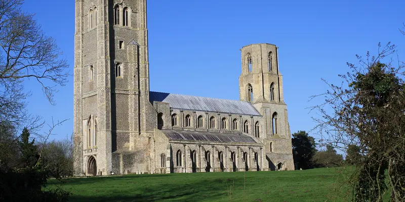 The twin towers of Wymondham Abbey across the meadow